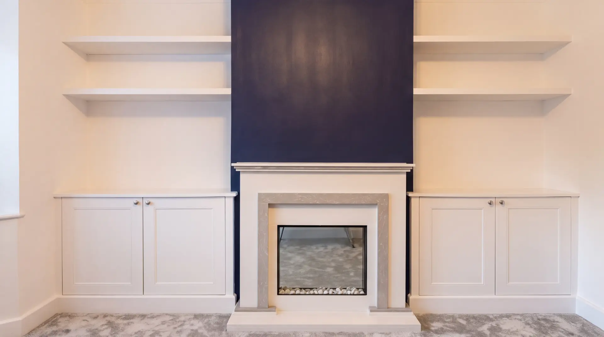 Modern living room with built in alcove joinery either side of a fireplace